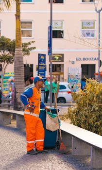 A street cleaner in bright uniform at work in Salvador, Brazil, showcasing urban daily life.