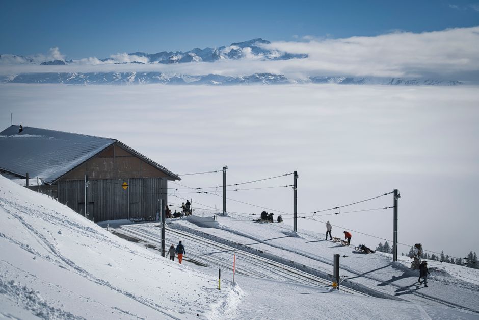 Enjoy a breathtaking snowy landscape at a ski resort with mountains and a serene sky view.