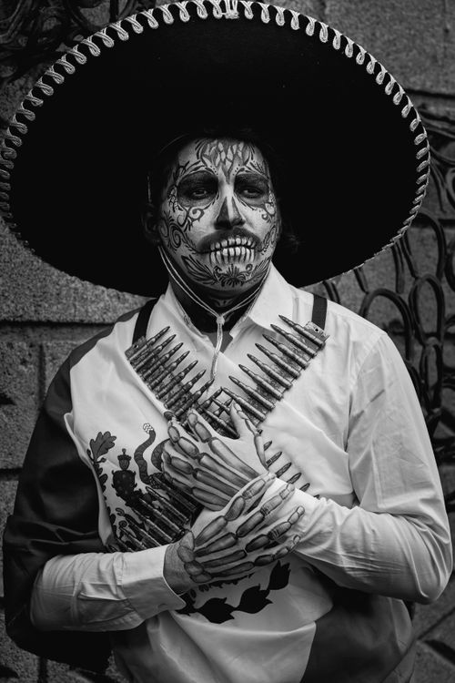 Free Black and white portrait of a man celebrating Dia de los Muertos with skull makeup. Stock Photo