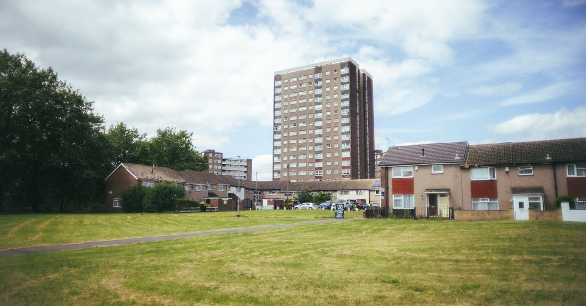 Urban residential area with tower block in Leeds, sunny day.