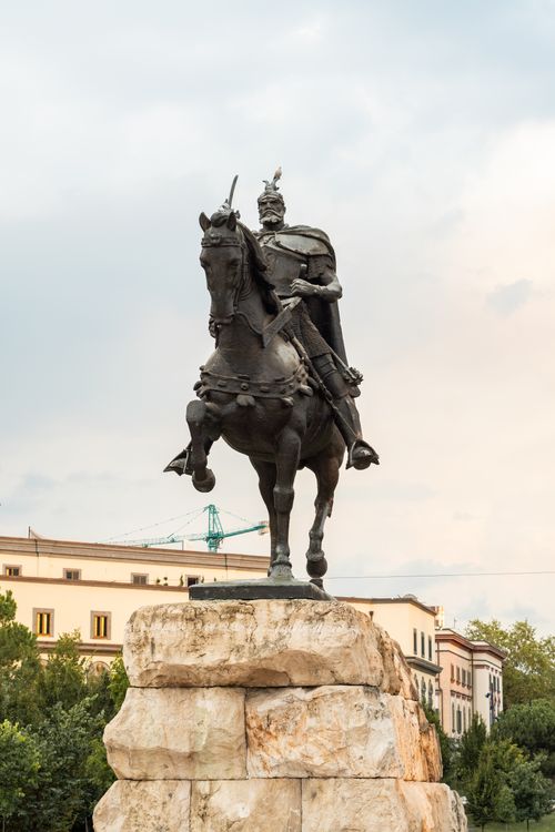 Free Statue of Skanderbeg in Tirana, Albania, showcasing historic architecture and art. Stock Photo