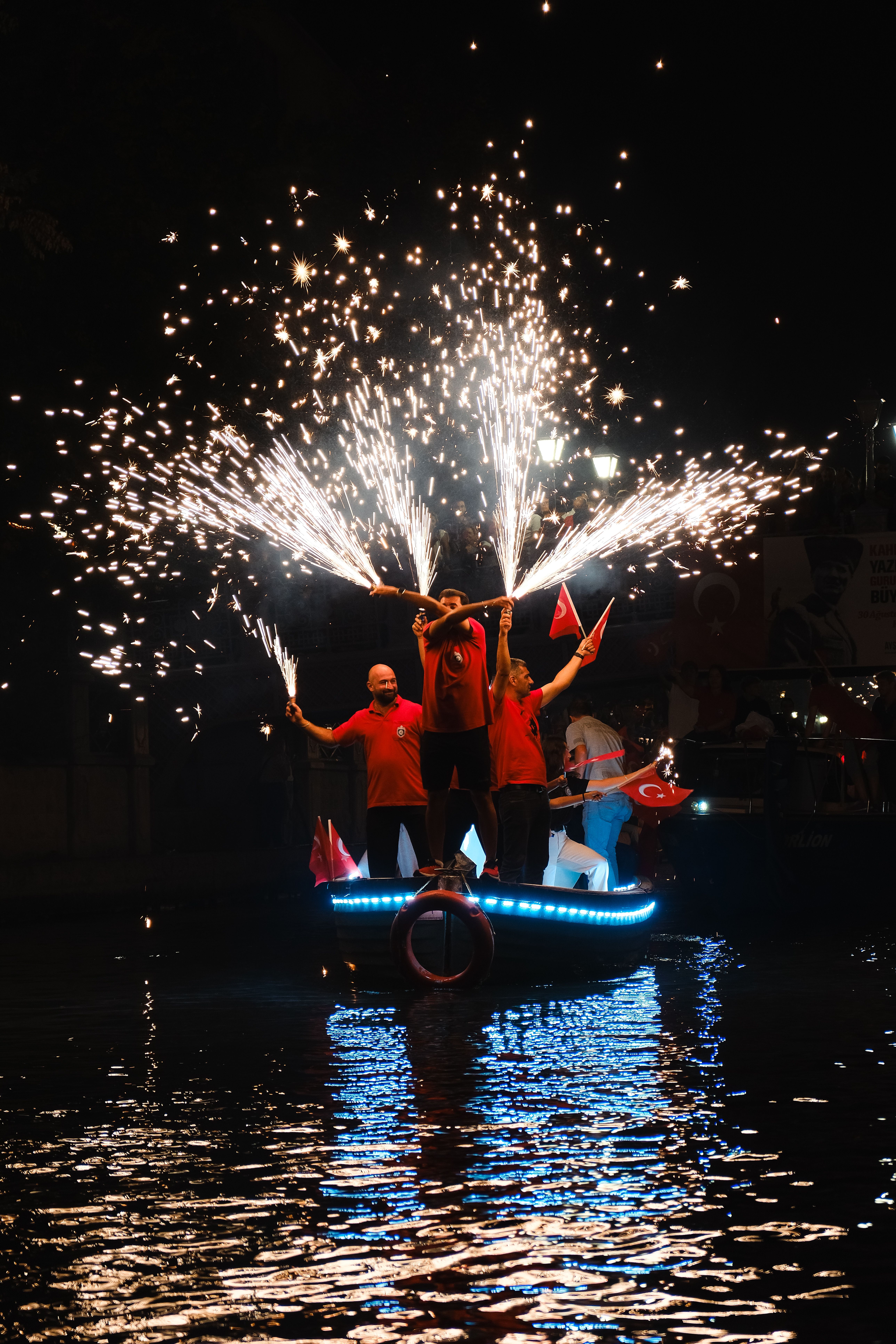 People celebrate with fireworks on a boat during a night event in Turkey.