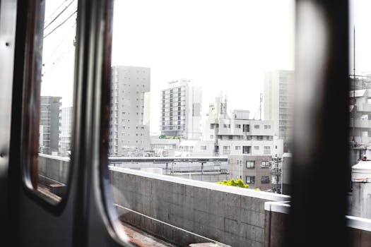View of Osaka city's urban landscape from a metro train window, Japan.