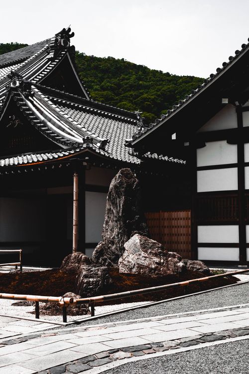 Free View of traditional Japanese architecture in Kyoto, featuring detailed roofs and serene garden. Stock Photo
