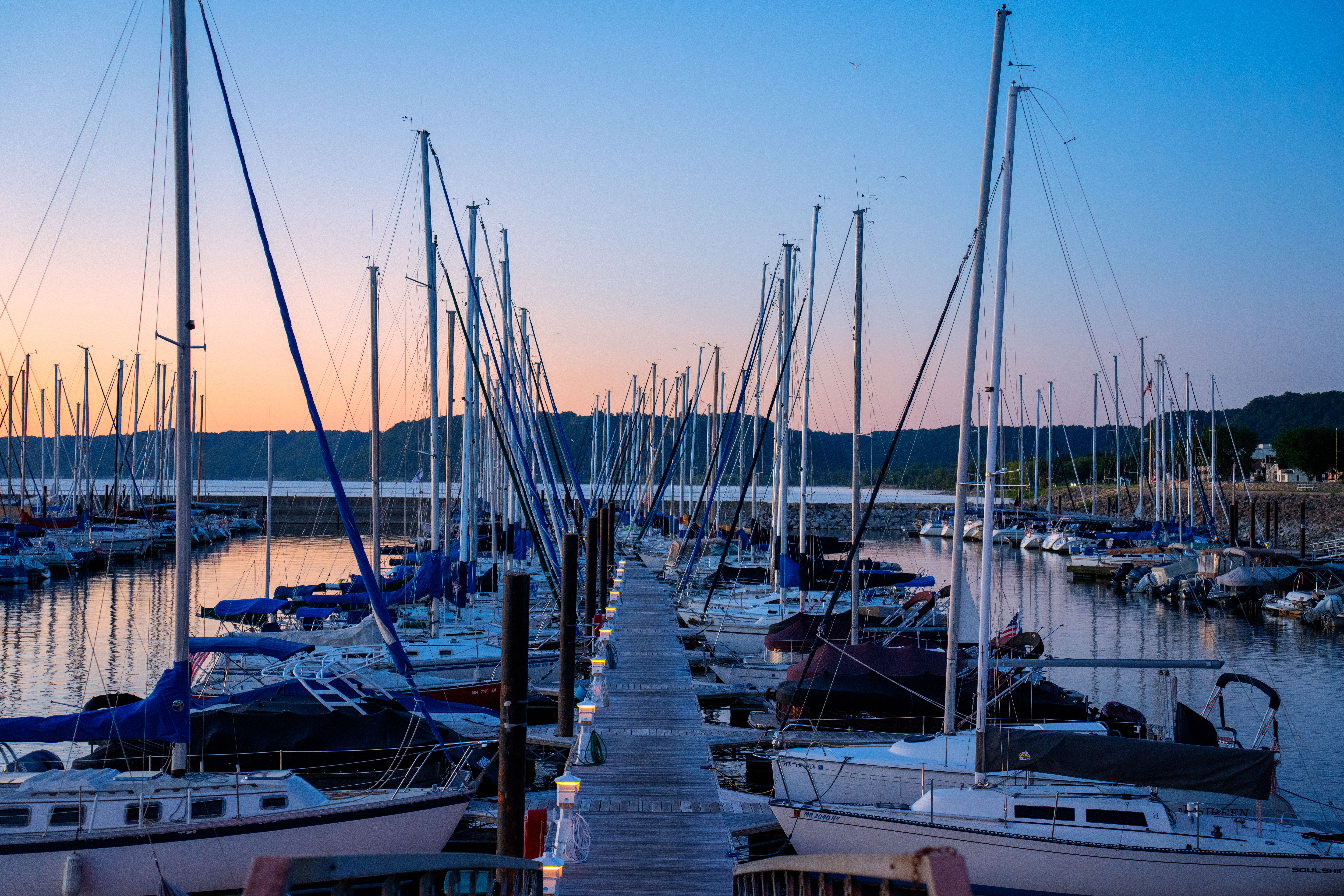 A dock with many boats docked at the end of it · Free Stock Photo
