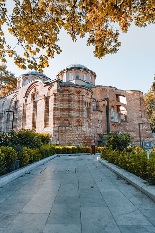 Free Explore this beautiful Byzantine architectural marvel surrounded by lush gardens and autumn trees. Stock Photo