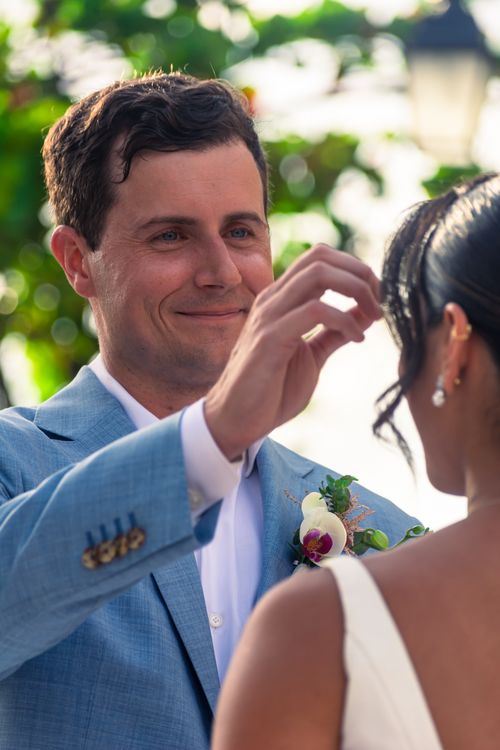 Free Emotional moment during an outdoor wedding ceremony with a couple in focus. Stock Photo