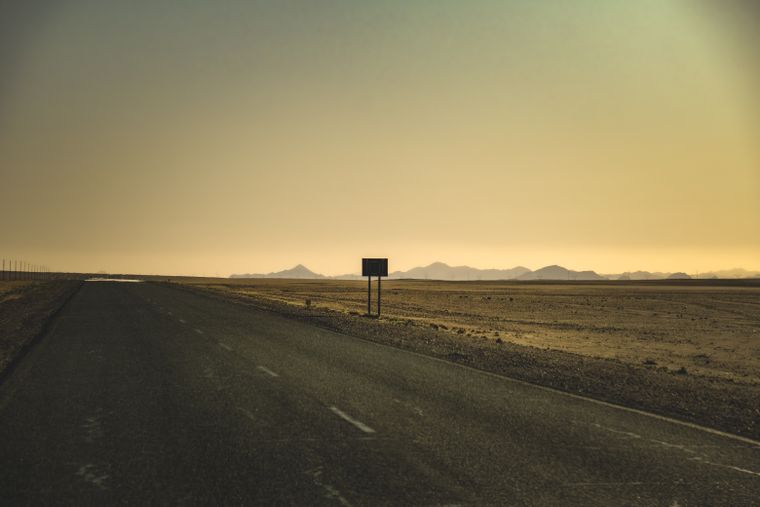 Empty desert highway at sunset, photo by Francesco Ungaro on Pexels