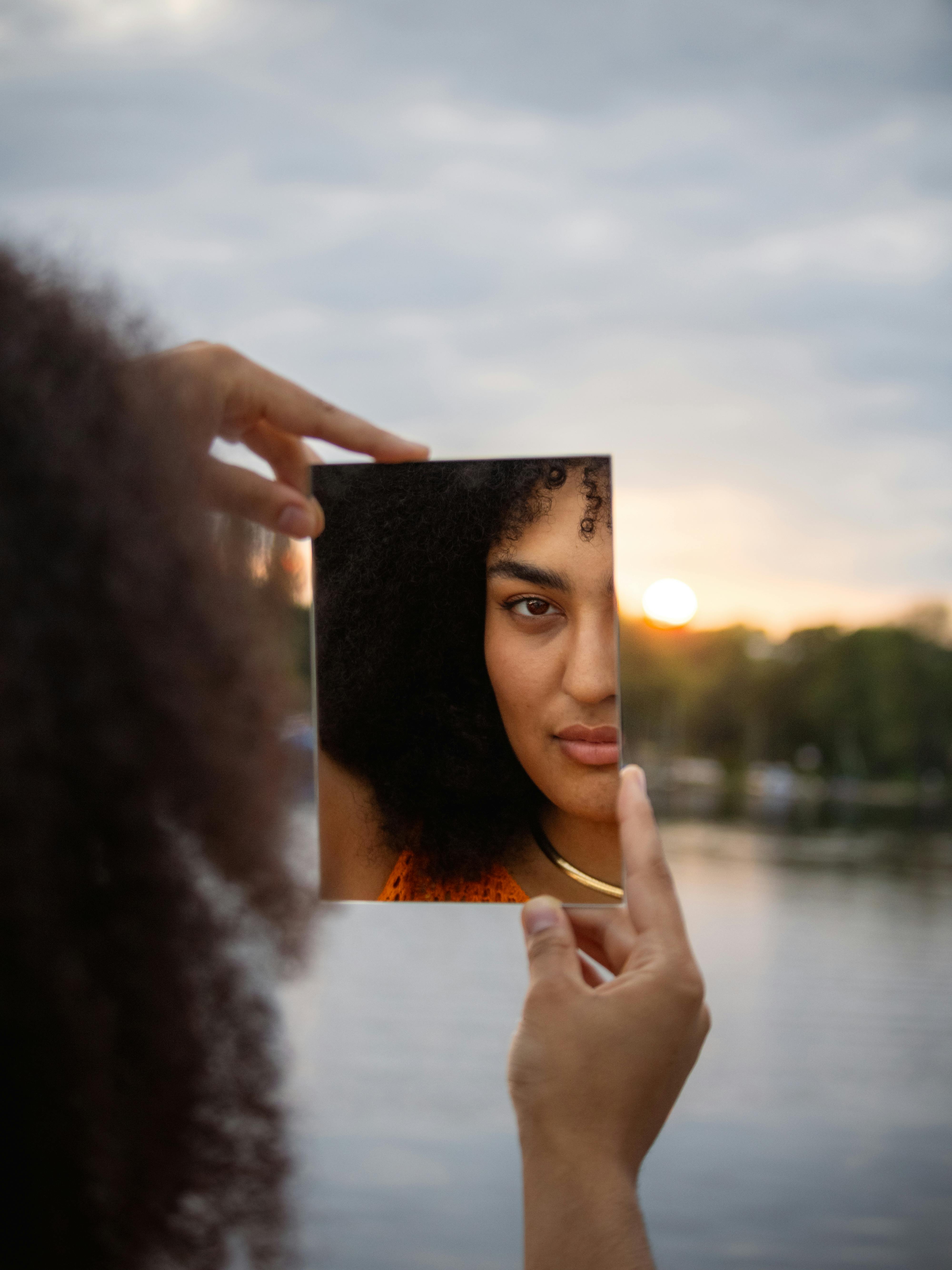 a woman holding up a photo of herself