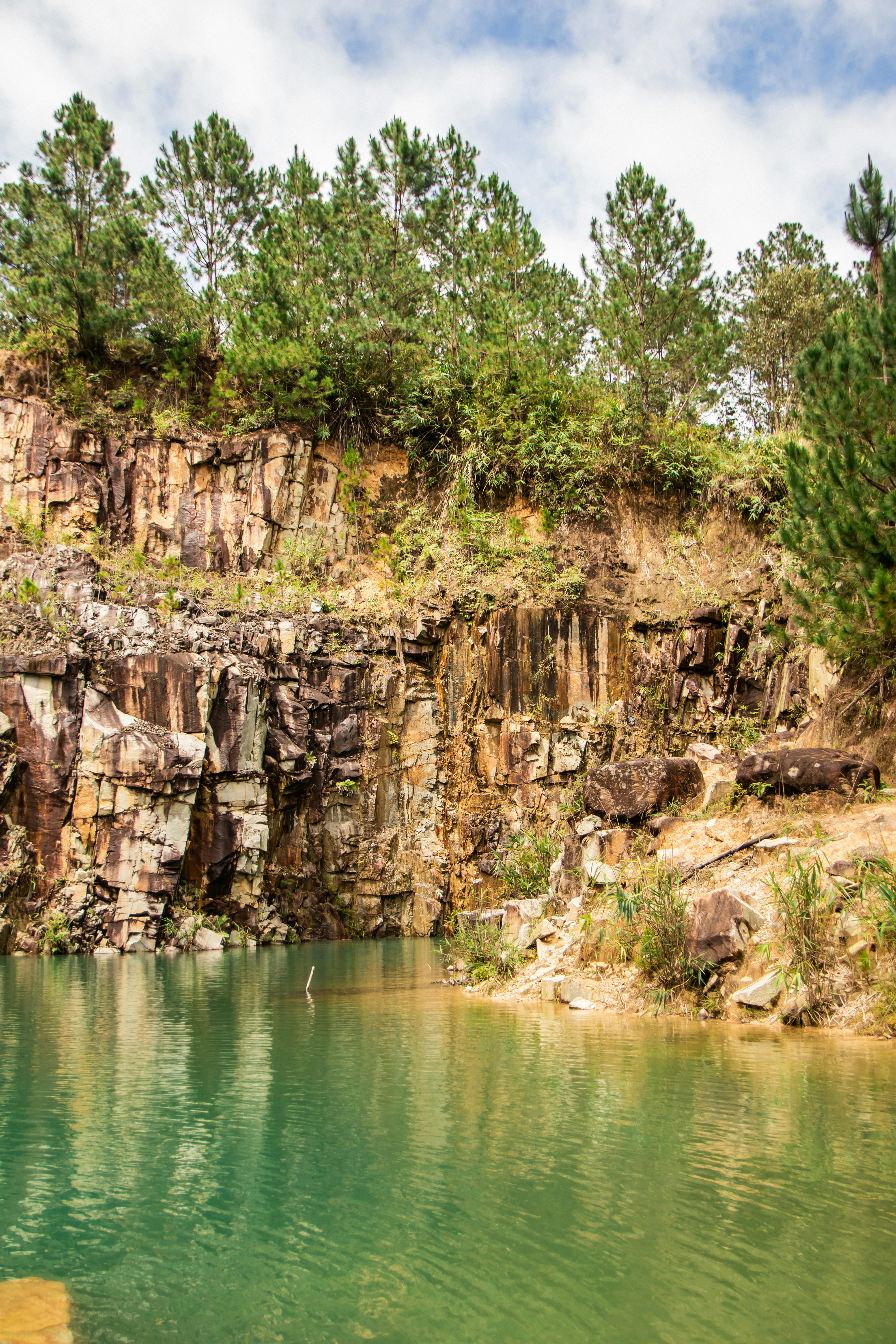 a large rock formation with a small lake in the middle