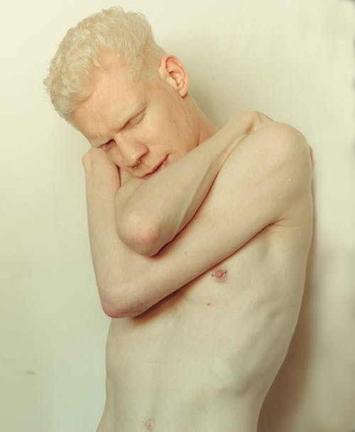 White-haired Topless Man Holding Shoulders Photo