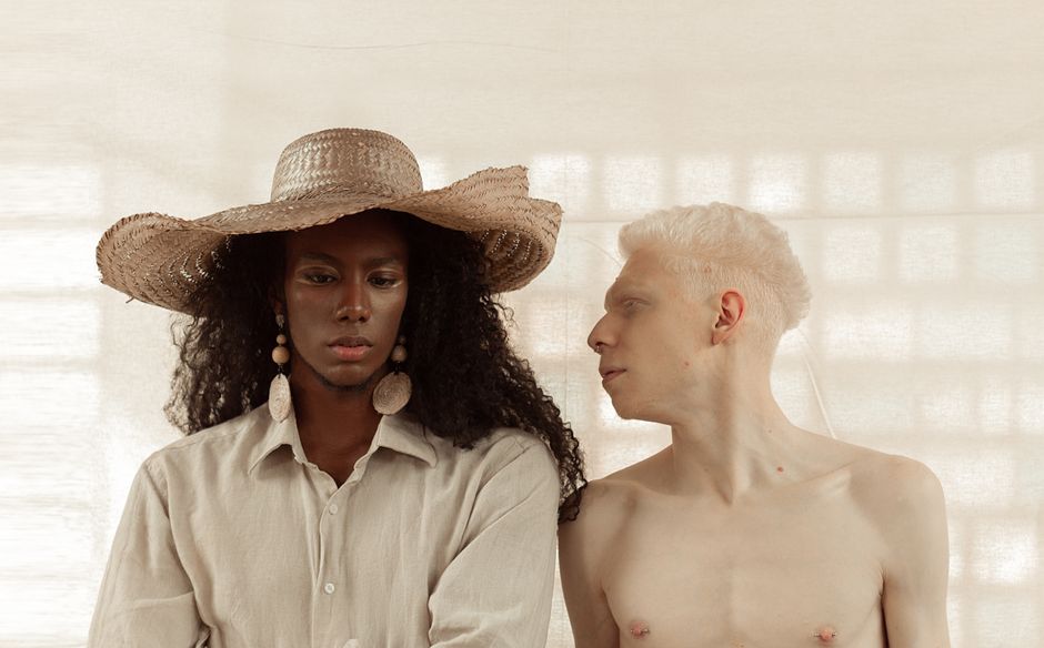 Exploring identity and diversity with an artistic portrait of two individuals in serene lighting.