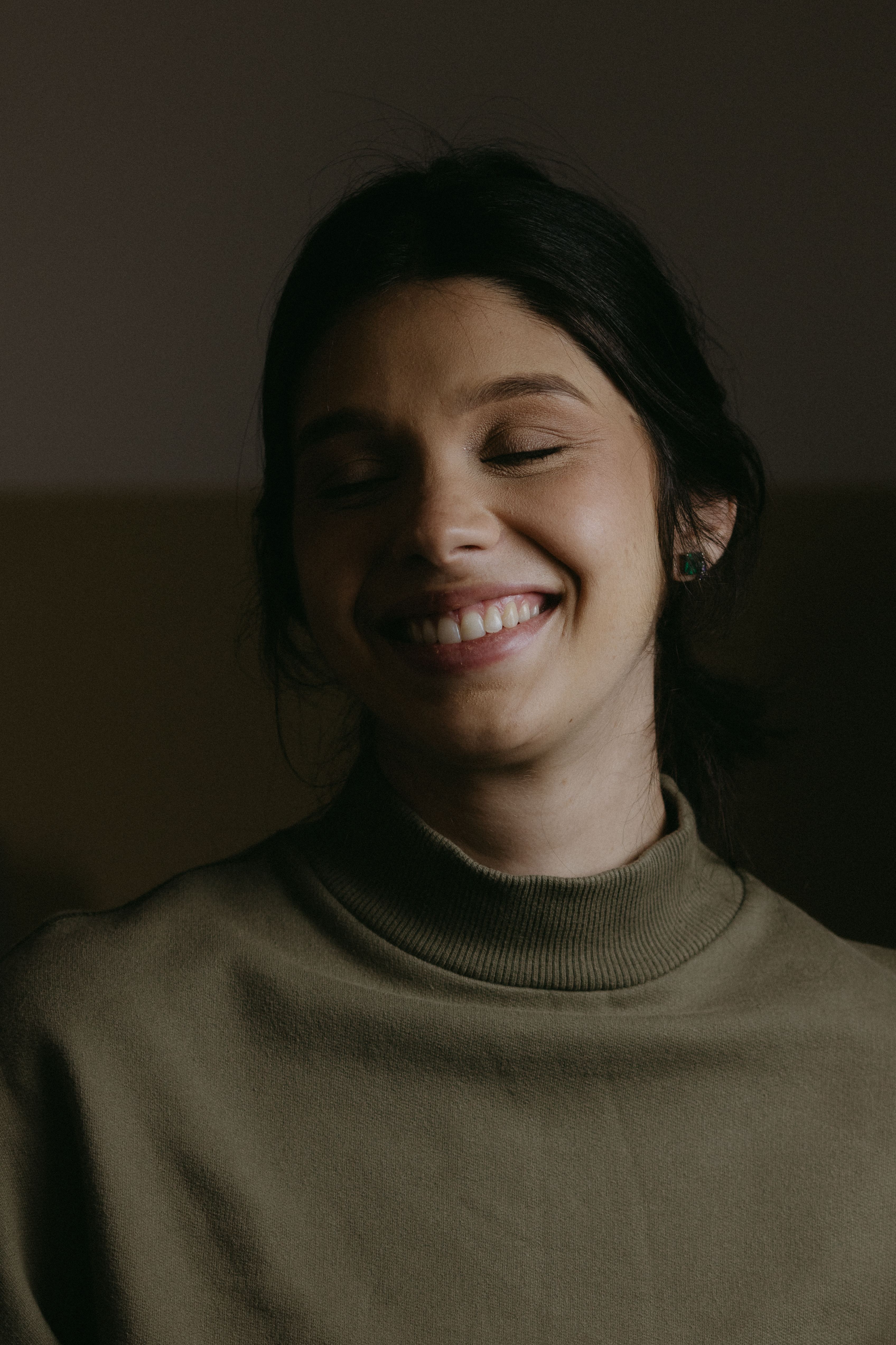 A woman smiling with her eyes closed · Free Stock Photo