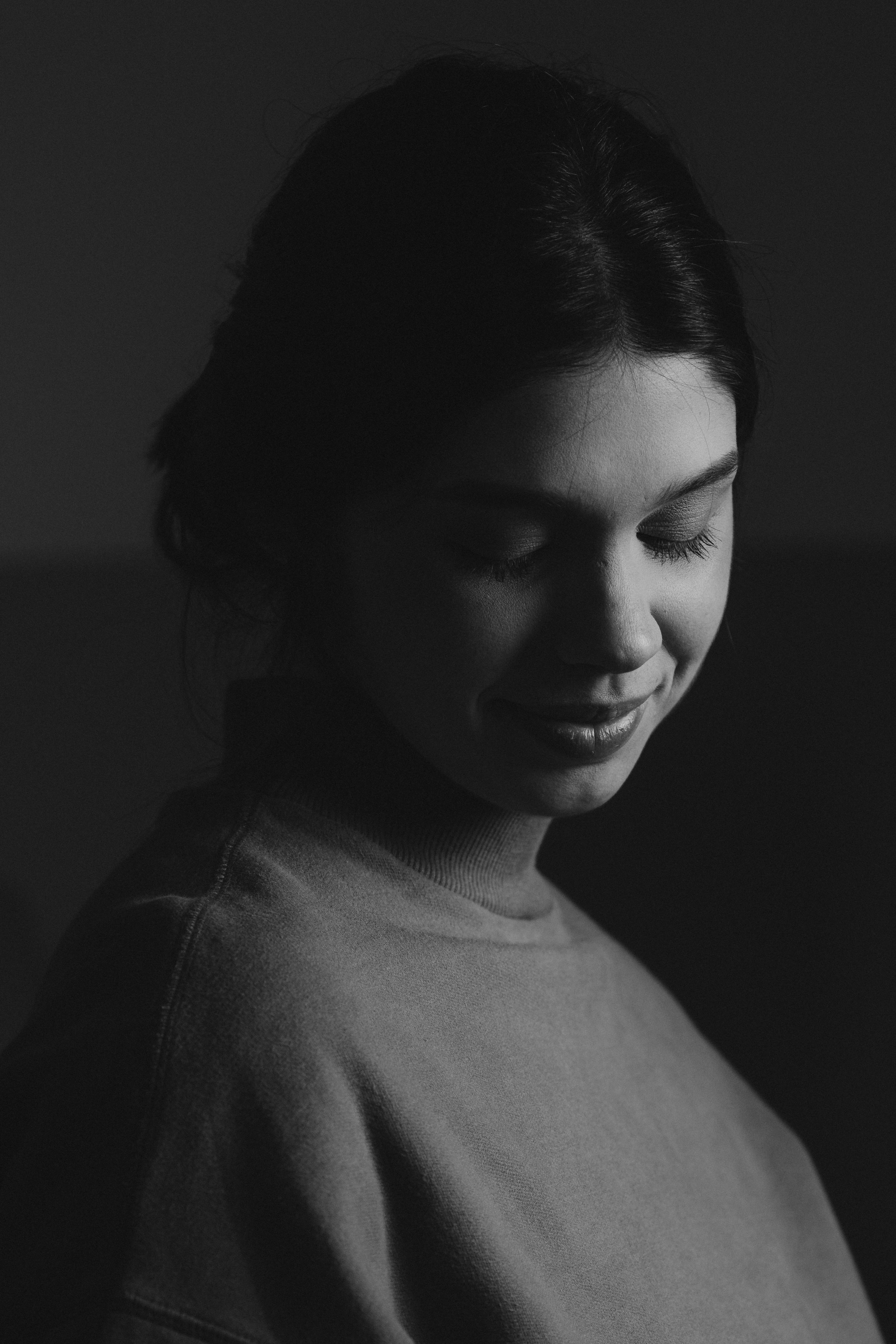 a black and white photo of a woman smiling