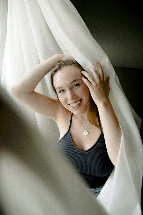 Smiling Woman Wearing Black Spaghetti Strap Top