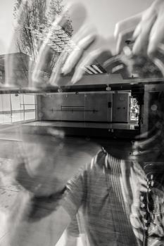 Creative black and white reflection of a musician with an urban backdrop.