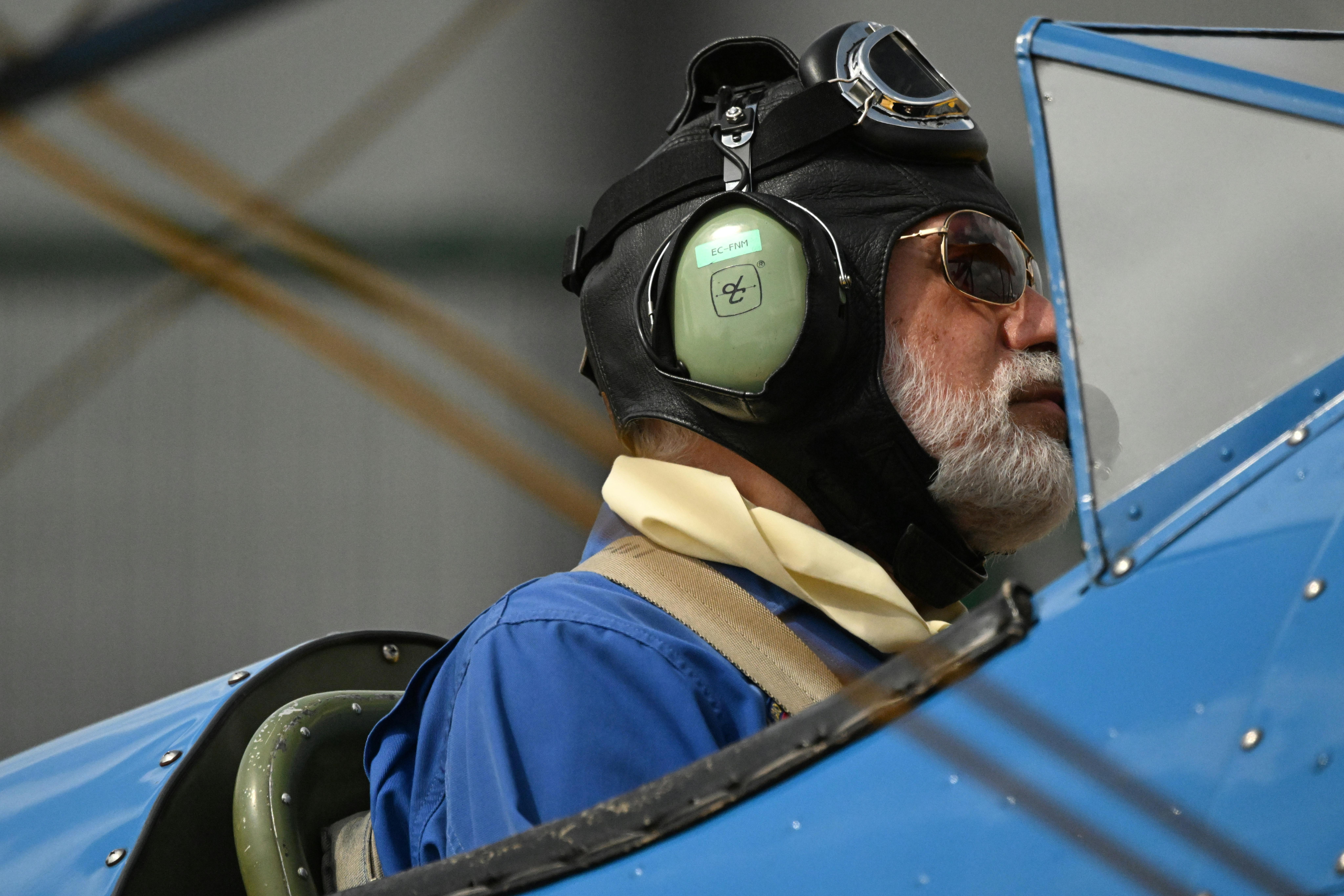 Portrait of an aviator in vintage aircraft gear preparing for takeoff.