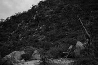 Serene black and white landscape with a folding chair in Cabo San Lucas, México.