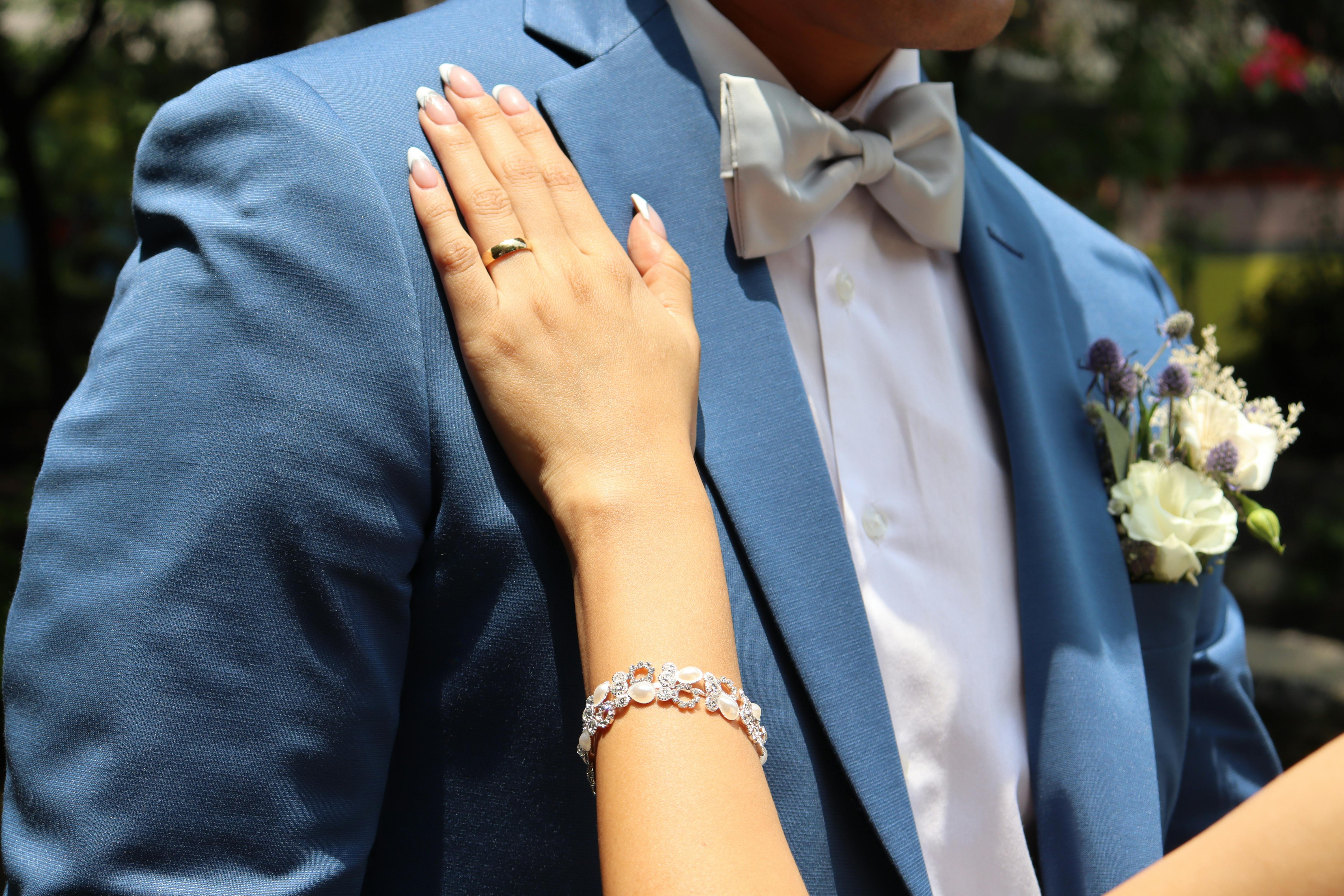 a man in a blue suit and a woman in a white dress