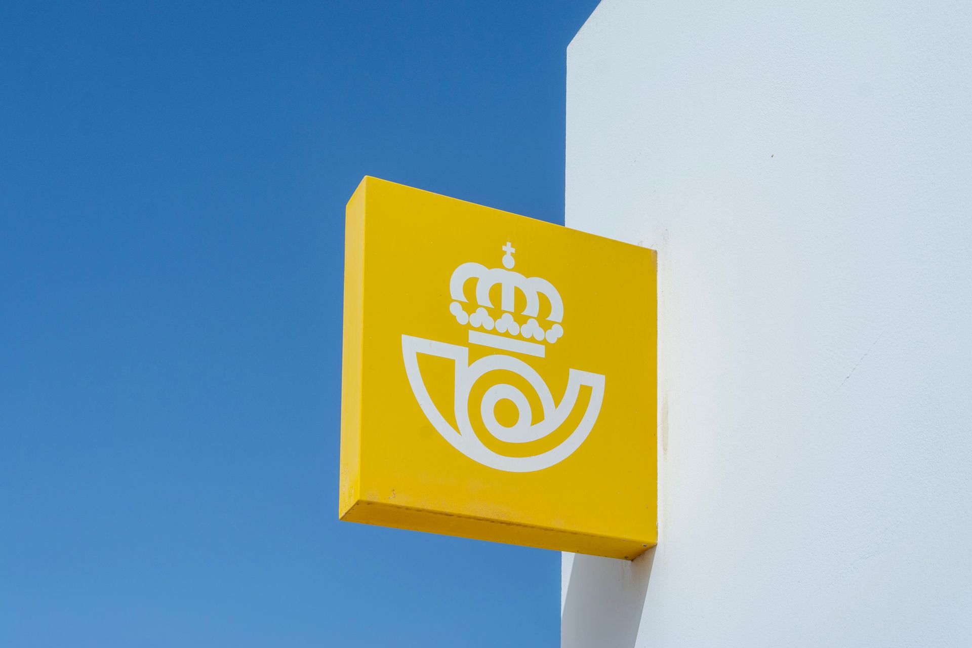 A yellow sign with a crown on it