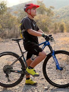 Young man mountain biking in the scenic landscape of Ojo de Agua, Mexico, during fall.