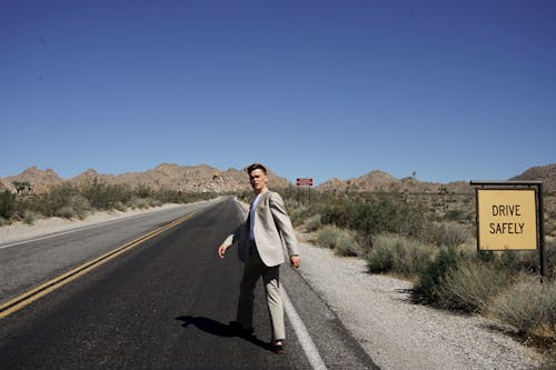 Free Man Standing on Road Stock Photo