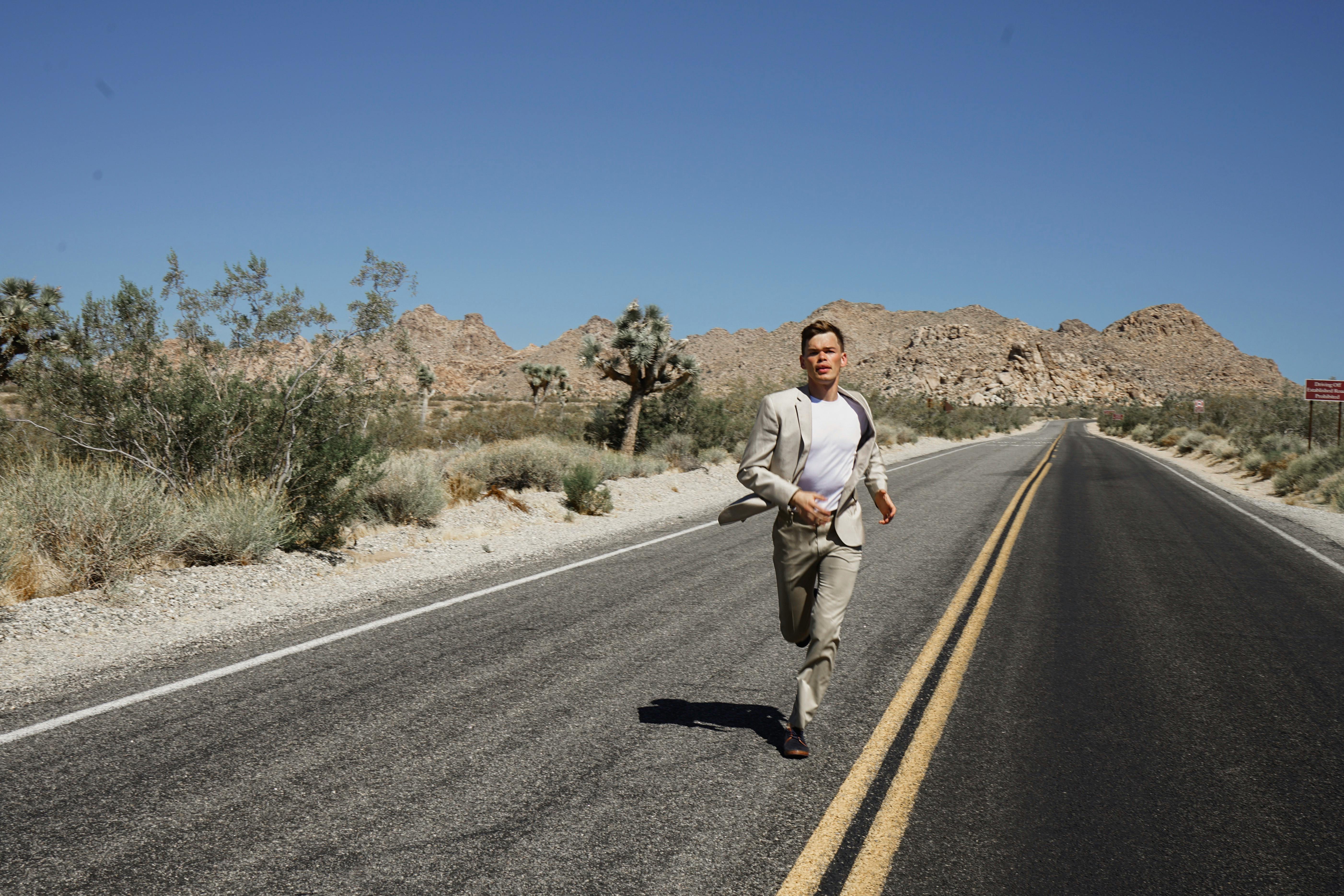 man running on empty road