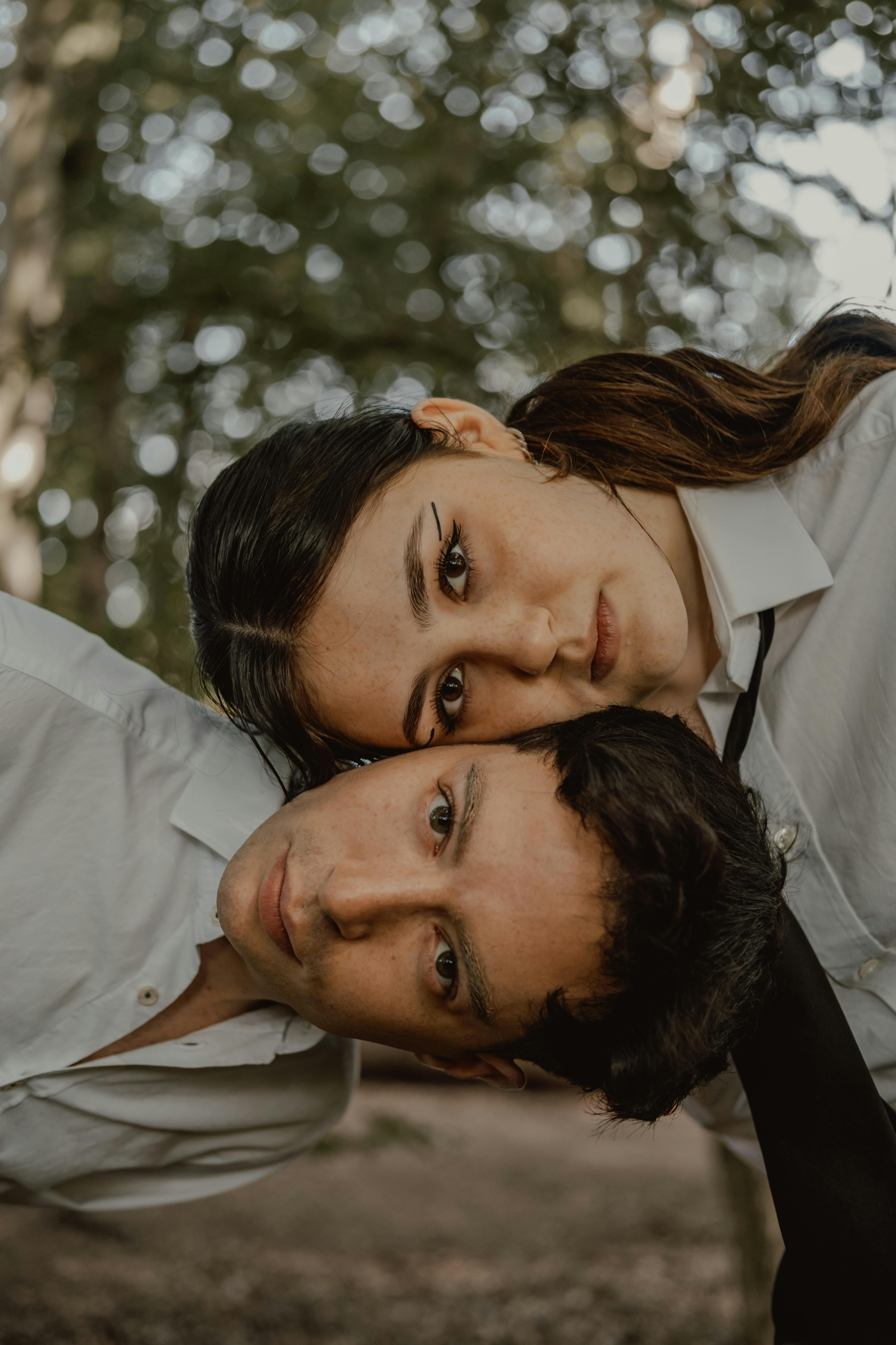 a man and woman in white shirts posing for a photo