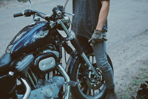 Person Standing in Front of Motorcycle