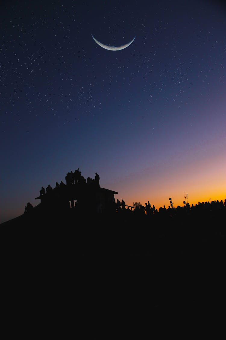 Silhouette Of People And House Under Moon