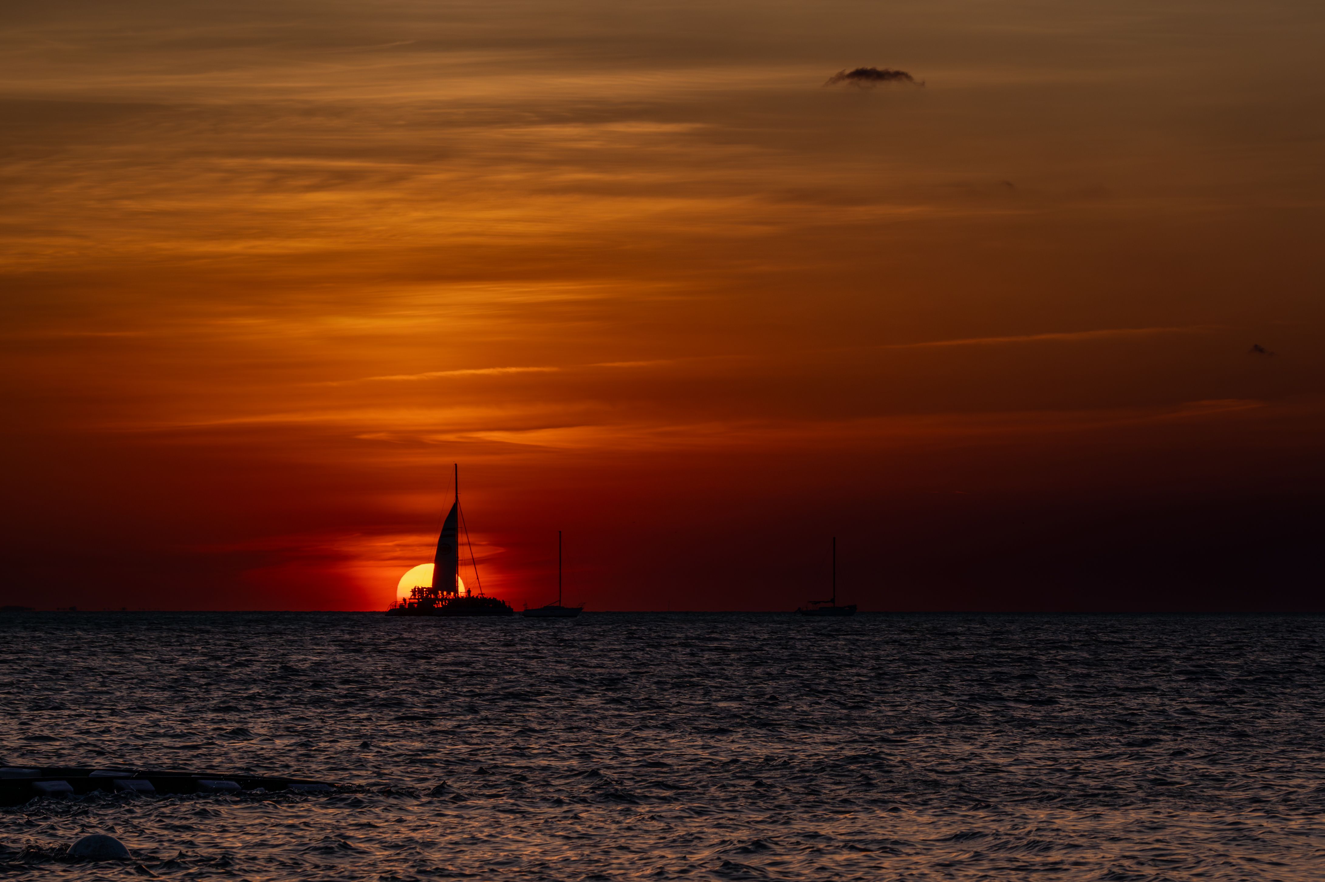 Silhouetted Sailboat on the Sea at Sunset · Free Stock Photo