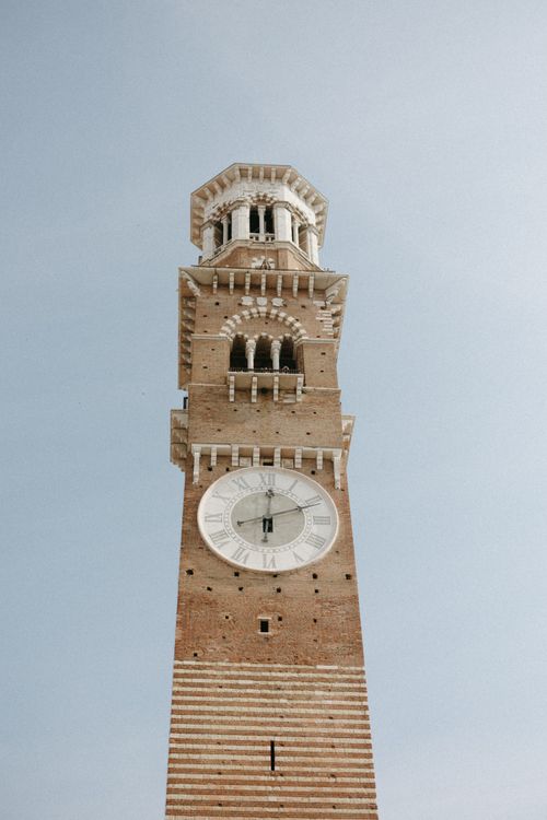 Free A majestic Gothic-style clock tower with intricate architecture photographed outdoors during the day. Stock Photo