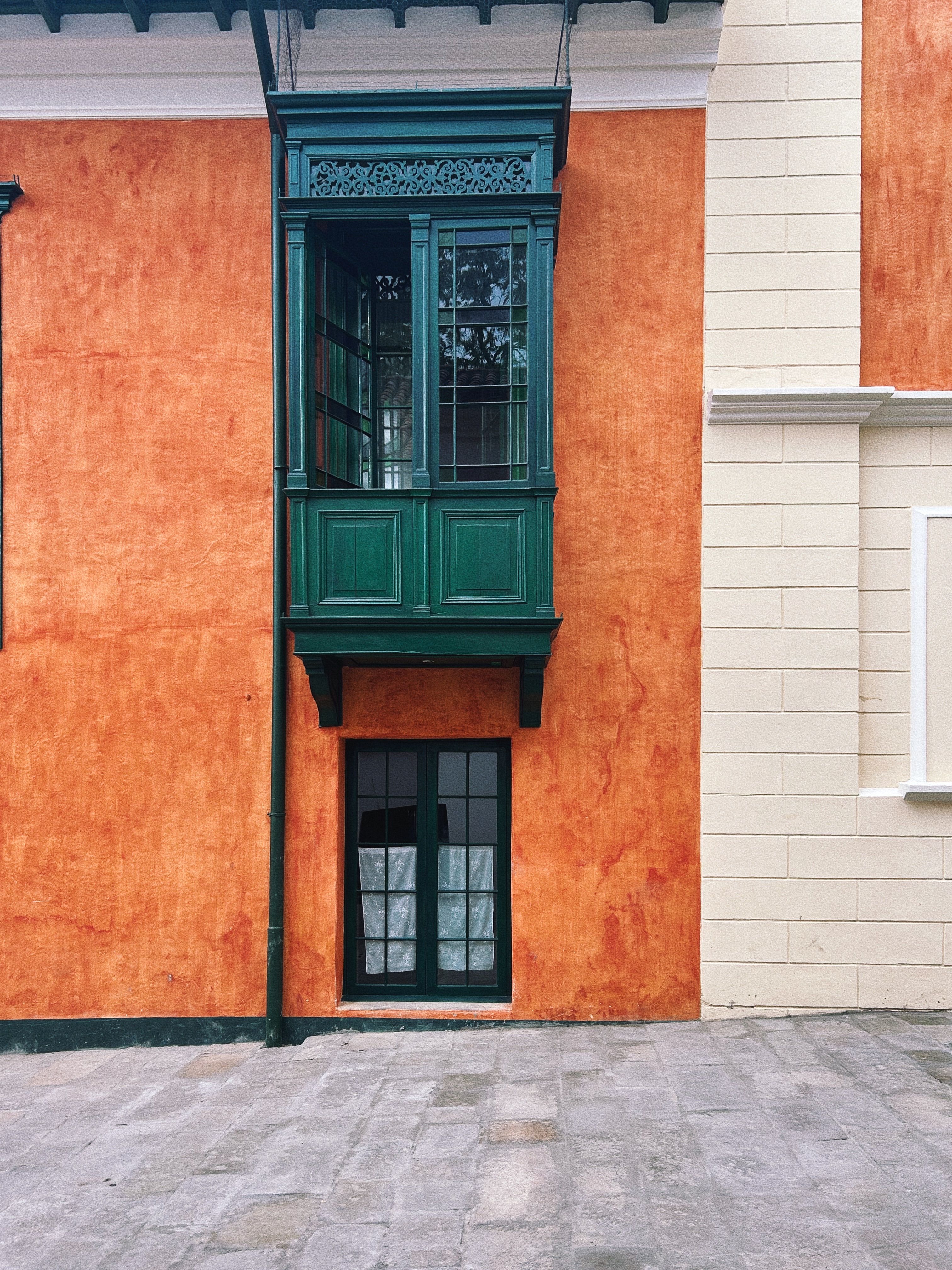 Vibrant colonial facade with ornate windows in Bogotá, Colombia.