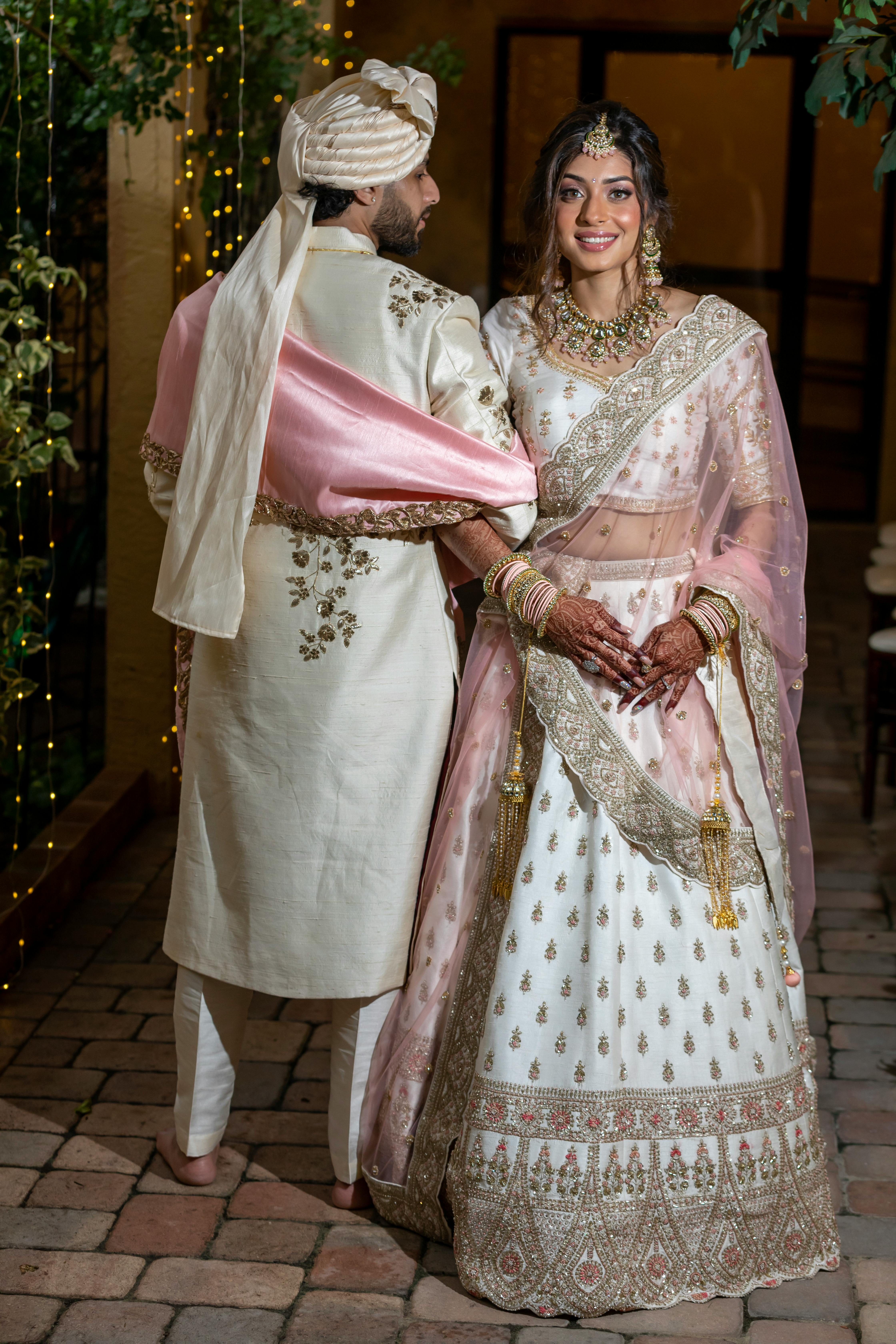 a bride and groom in traditional indian attire