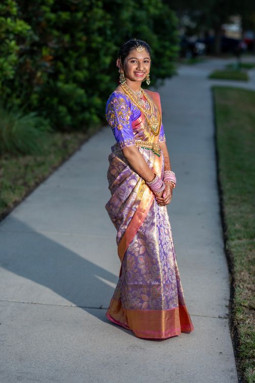 Free A woman poses outdoors in a colorful traditional saree, showcasing cultural fashion. Stock Photo