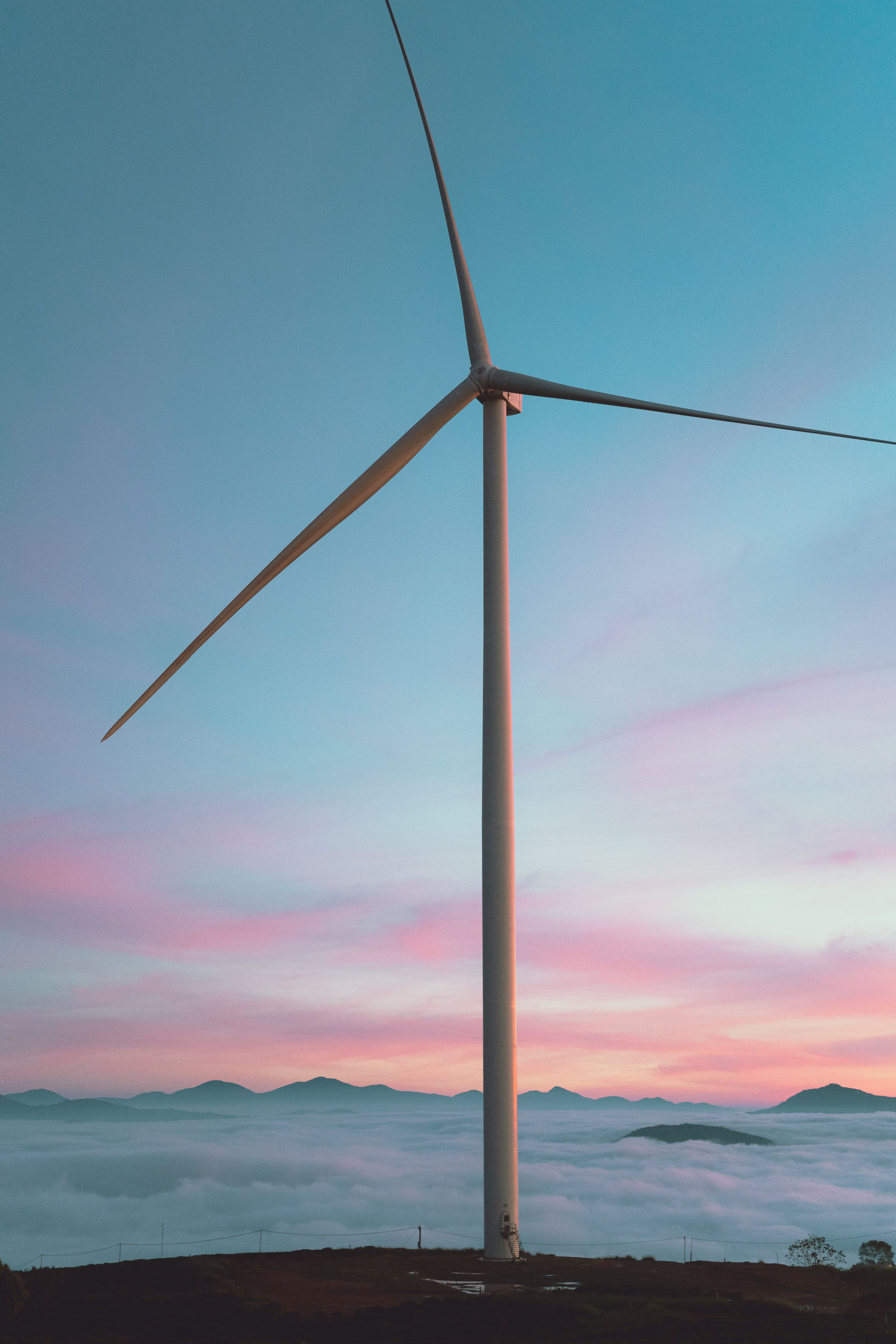 Wind Turbines at Sunset Over Rolling Hills · Free Stock Photo