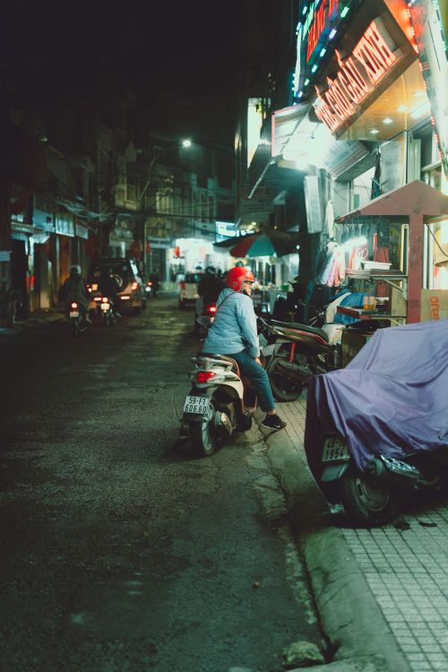Free Vivid street scene in Dalat, Vietnam showing a motorcyclist at night. Stock Photo