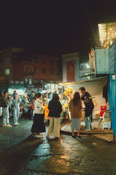 Bustling night market in Dalat, Vietnam showcasing local lifestyle, vendors and shoppers.