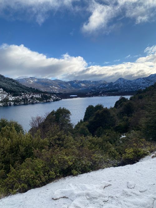 Free Captivating winter landscape of a lake surrounded by snow-covered mountains in San Martín de los Andes, Argentina. Stock Photo