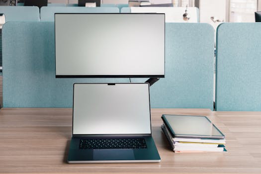 A clean workspace featuring a laptop and monitor in a modern office setting.