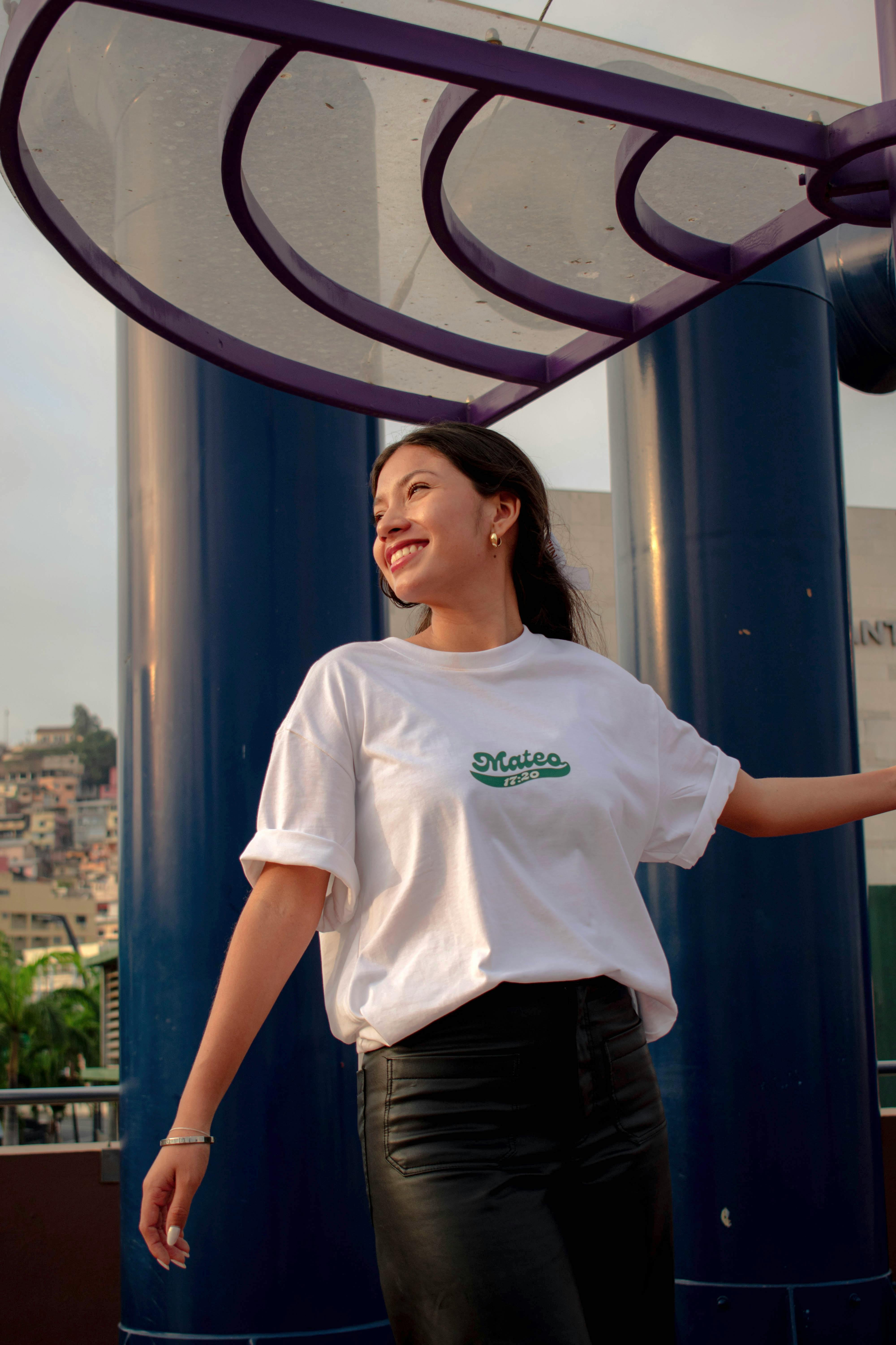 a woman in a white t shirt and black leather skirt