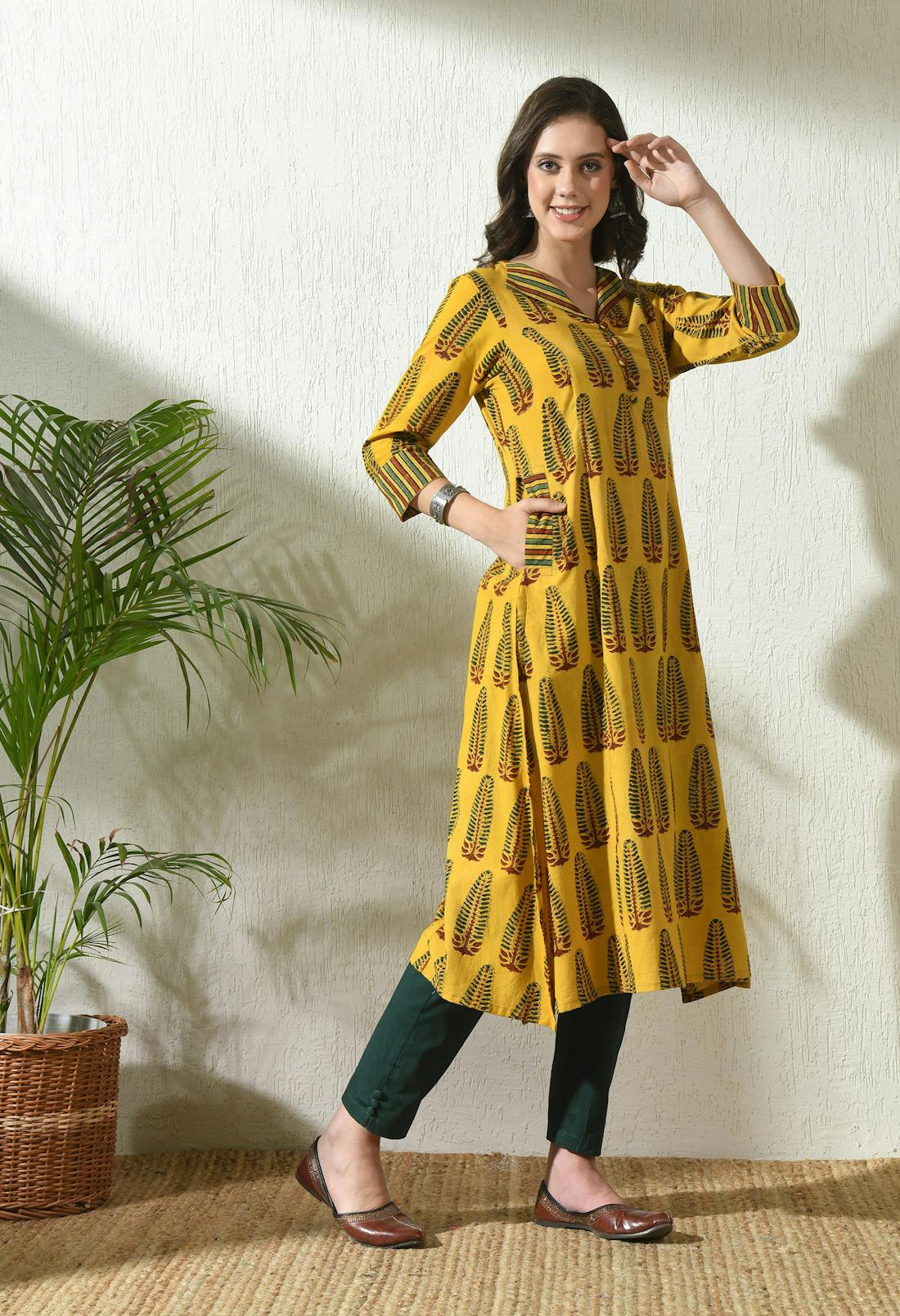 Woman modeling an Ajrakh printed kurta with border detailing along the hem
