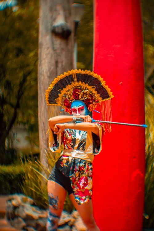 Free Colorful portrayal of a traditional performer holding a sword outdoors in Ciudad de México. Stock Photo