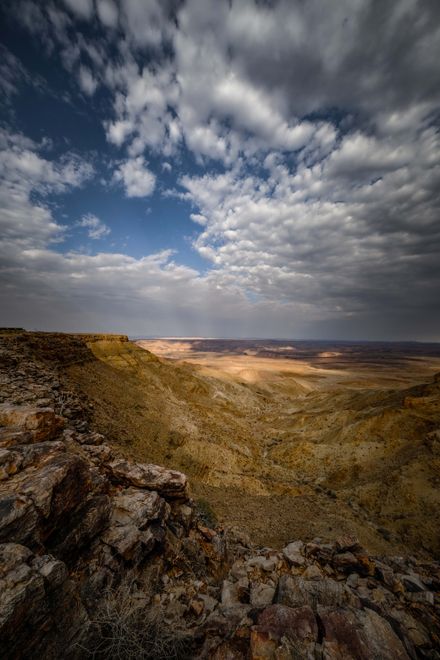 A desert canyon under heavy storm clouds — photo by Francesco Ungaro on Pexels