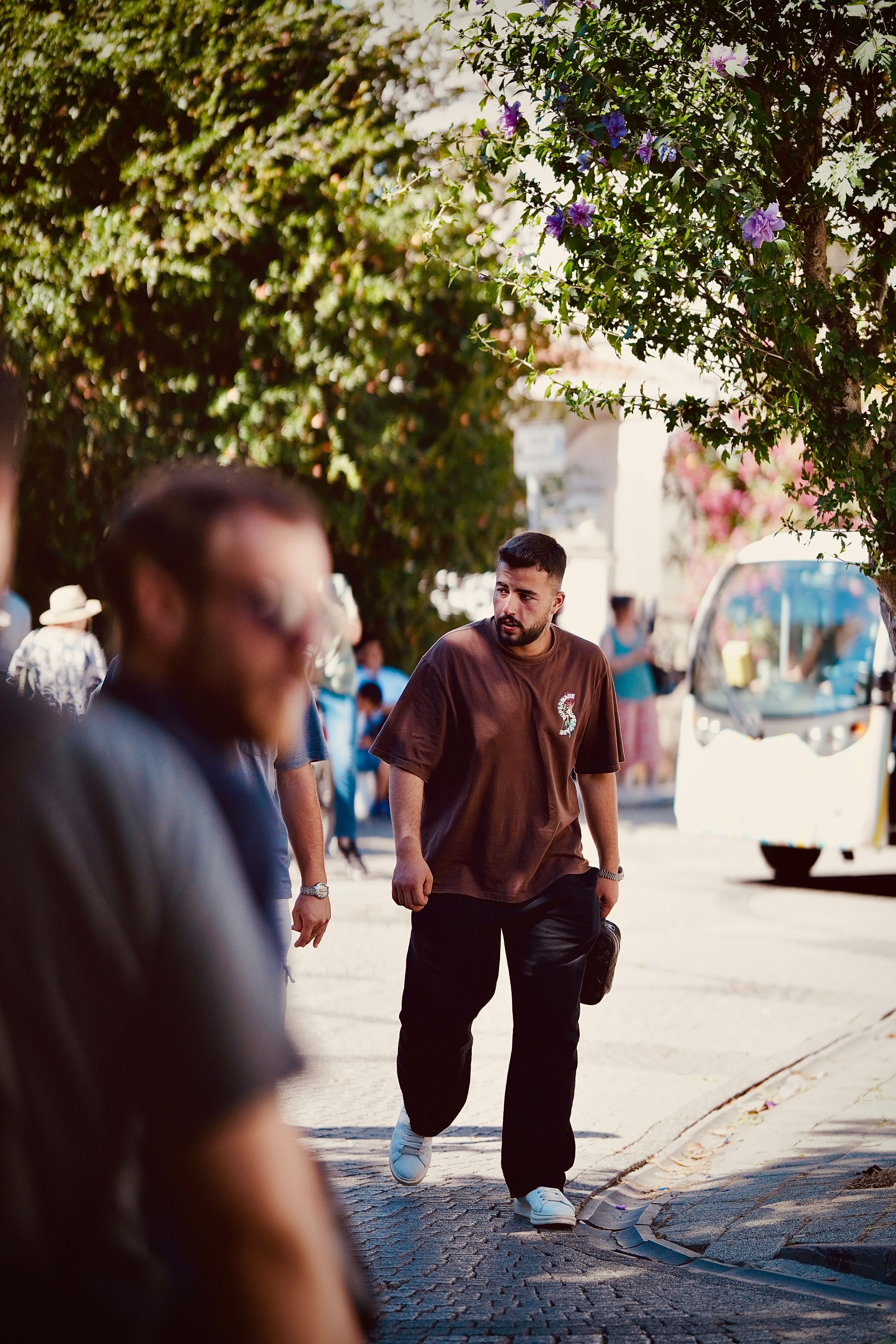 A man walking down a street with a skateboard · Free Stock Photo