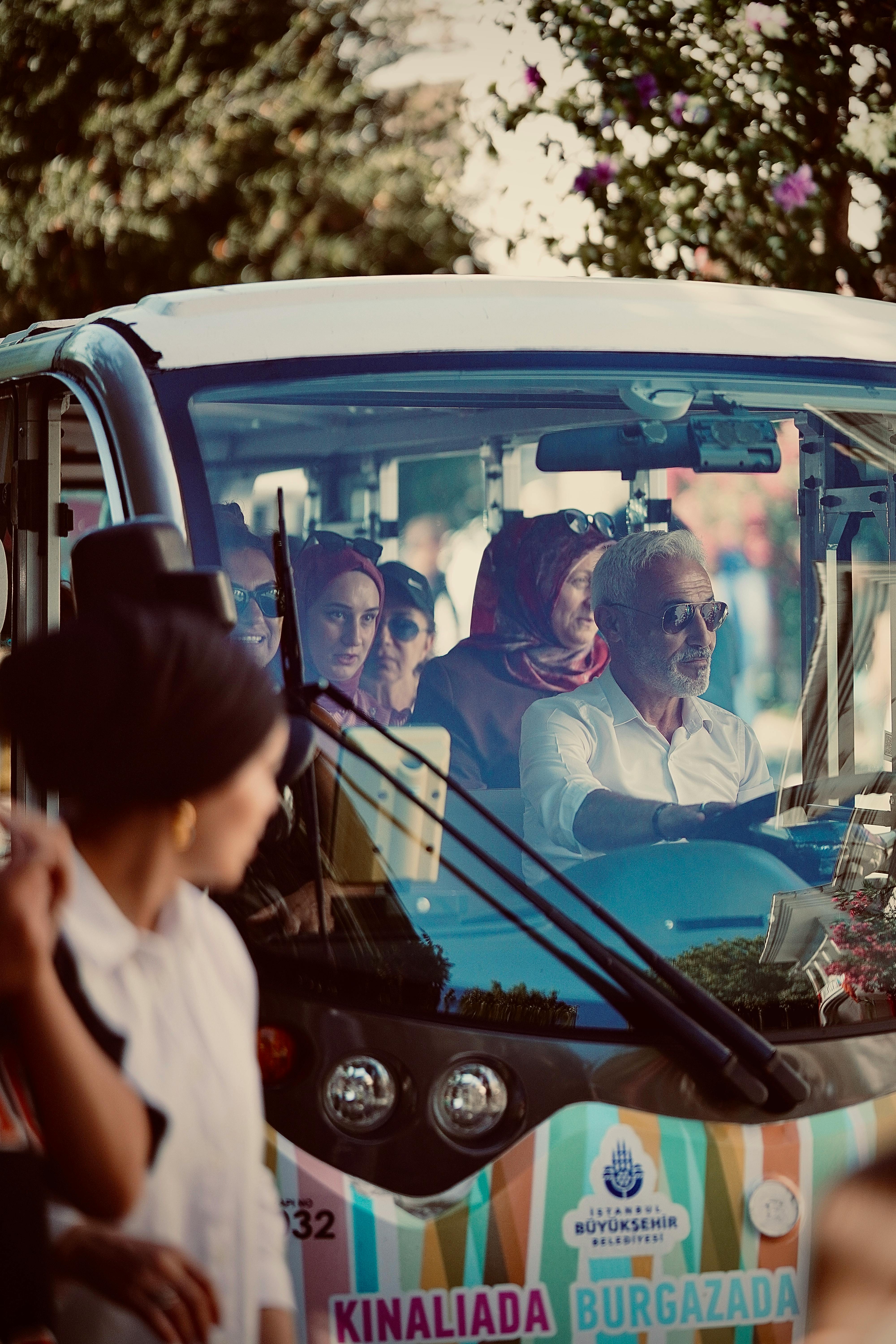 a group of people riding in a small bus