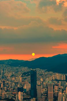 A stunning cityscape with tall skyscrapers at sunset, capturing the vibrant urban life.