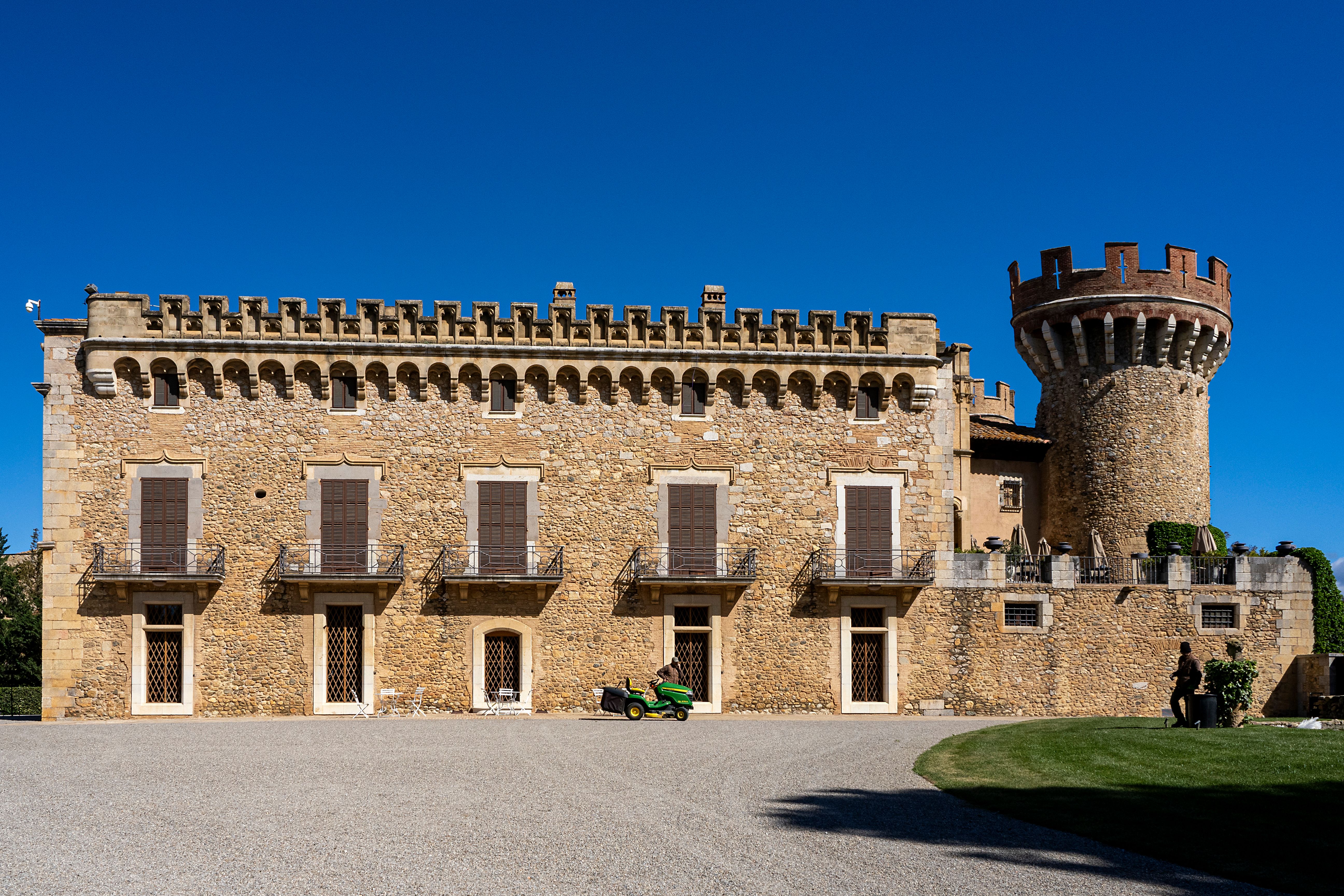 Explore a historic medieval castle with a unique tower in Peralada, capturing its architectural splendor.
