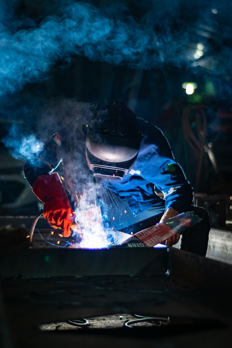 Welder in flame retardant clothing