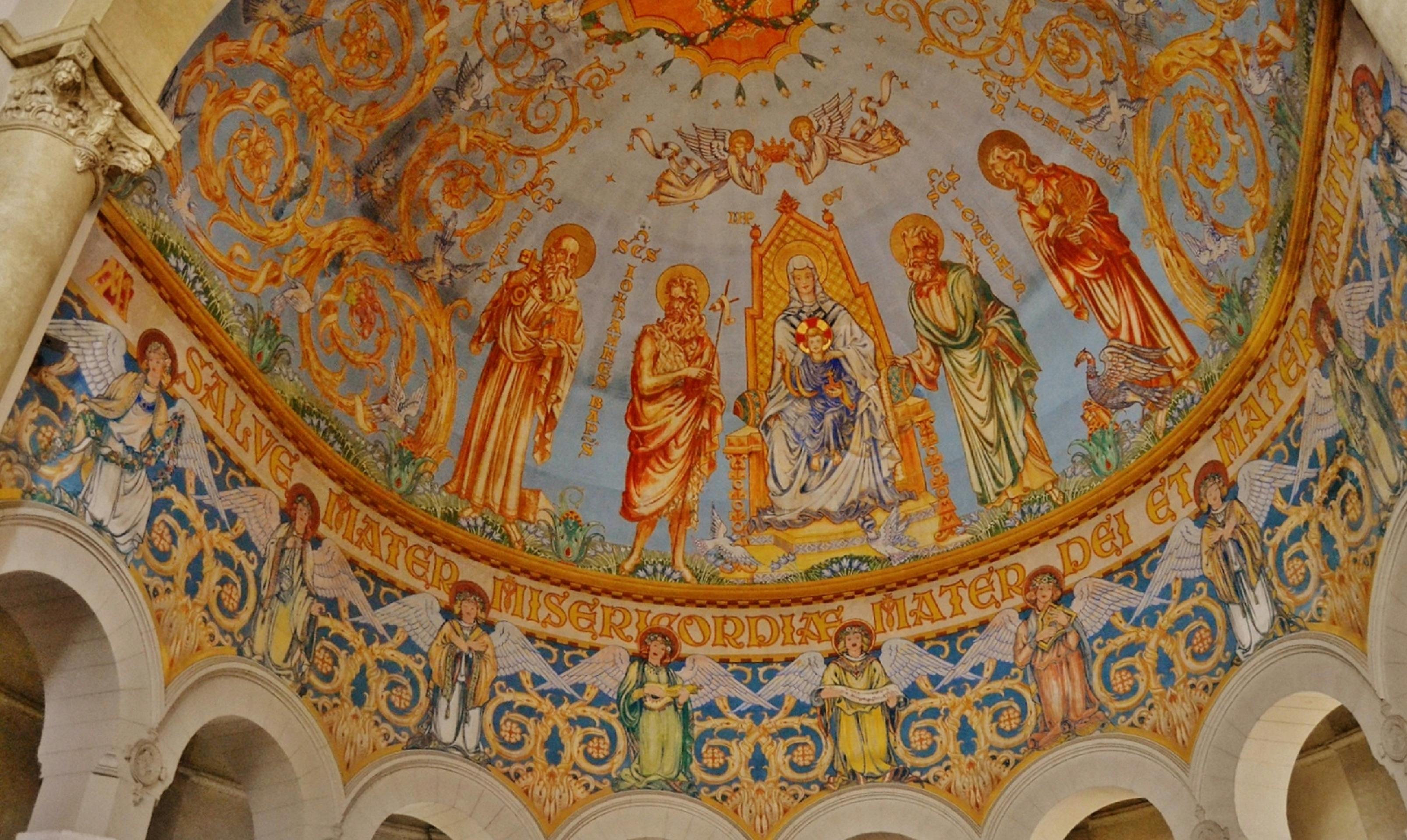 the ceiling of the church is decorated with paintings